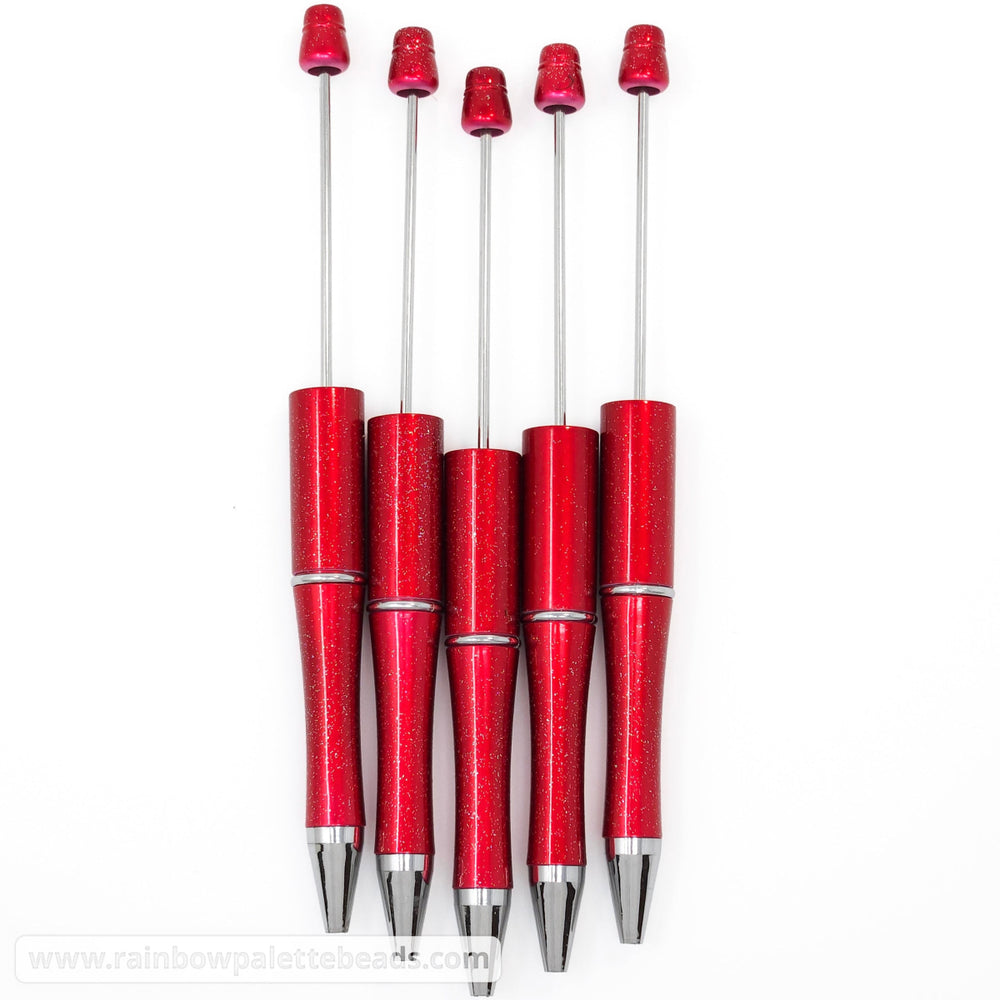 Set of red pens with silver accents on a white background